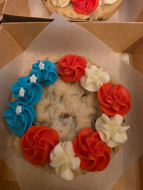 A cookie cake, dressed for a celebration