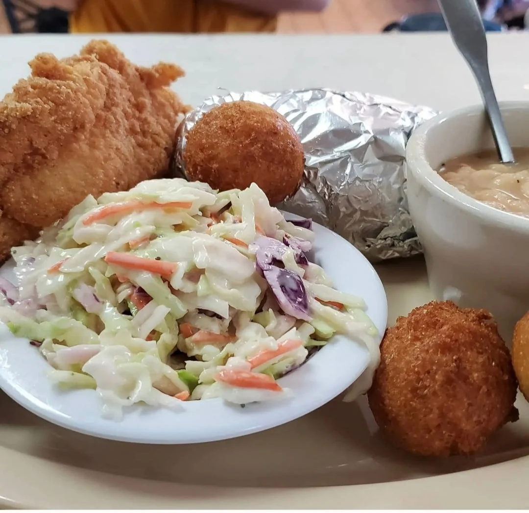 Fried fish with slaw, hushpuppies, white beans and a foil-wrapped potato