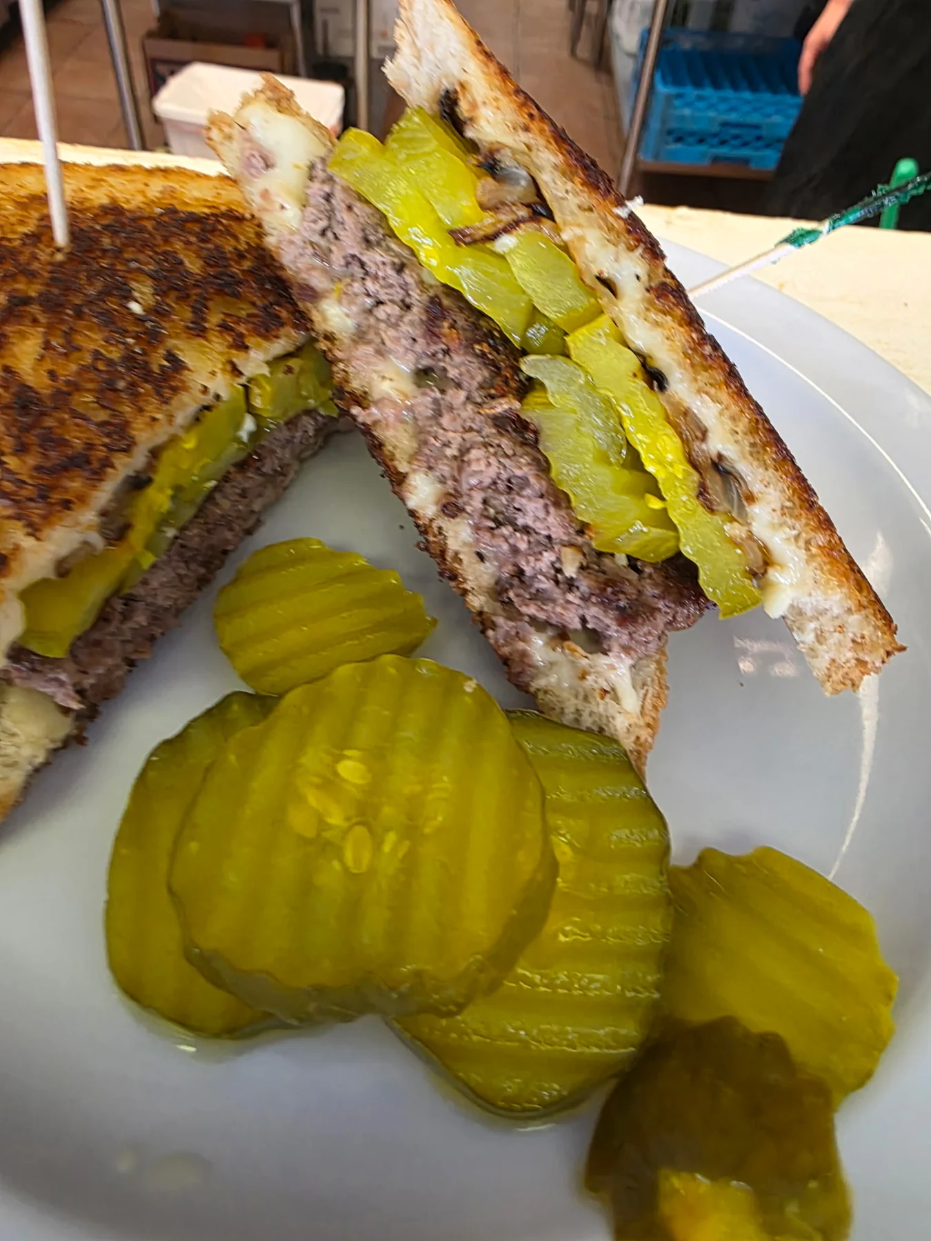 Griddled beef and cheese sandwich with pickles
